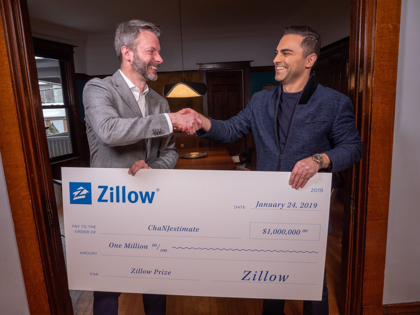Zillow Prize winners holding a one million dollar prize check